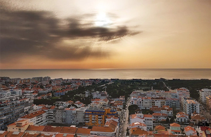 Stunning sunset view over the Atlantic ocean from Costa da Caparica, one of the most quiet places in Portugal to relax during a city break.