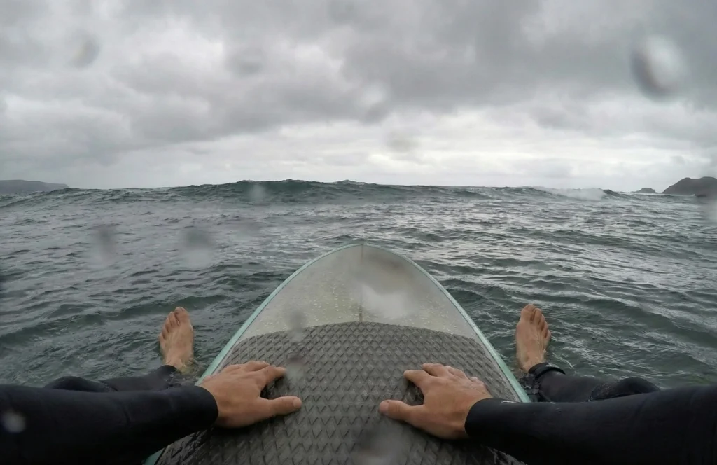 A beginner surf lesson at Praia de Santo Antonio, an ideal outdoor activity for busy professionals on a wellness Lisbon weekend.